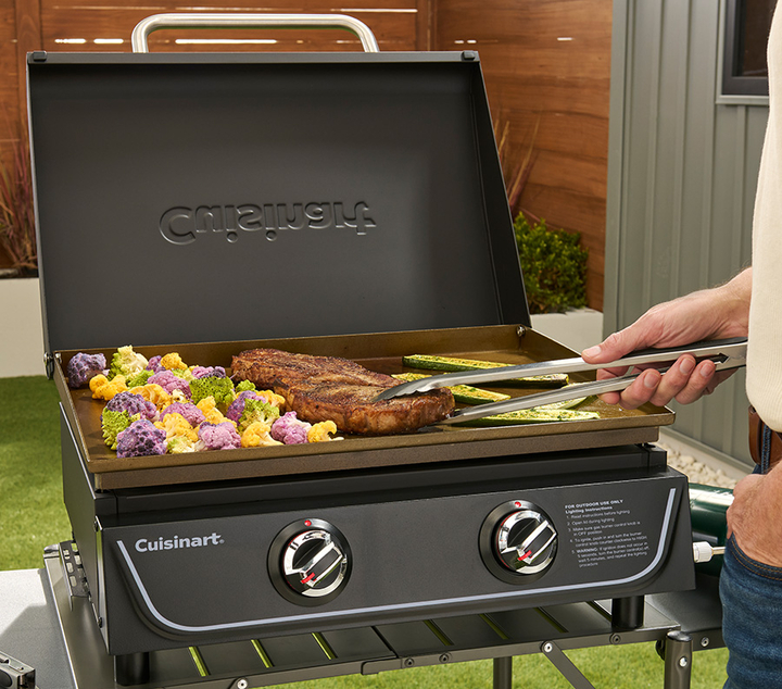 steak and vegetables cooking on griddle